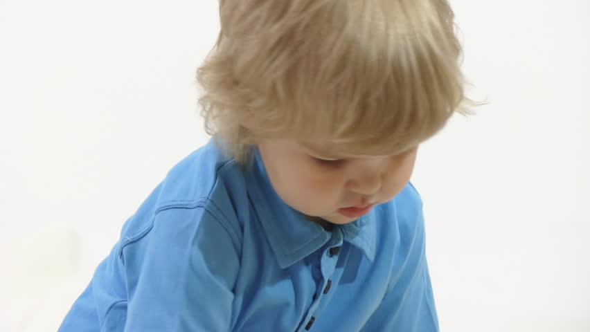 boy playing with toy in white room