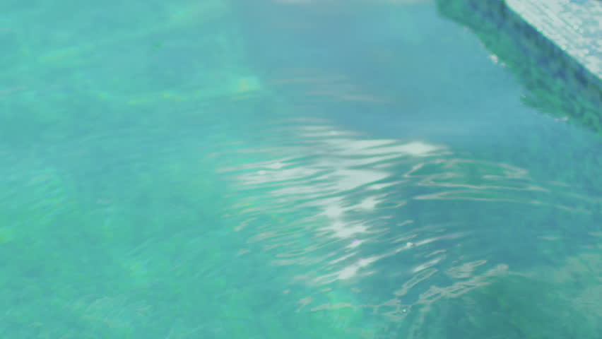 piano fall down in pool and makes many splash in slow motion