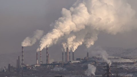 Pipes of the Industrial Enterprise Emit Smoke Air Pollution.