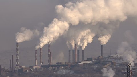 Pipes of the Industrial Enterprise Emit Smoke Air Pollution.