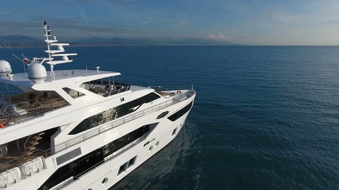 CANNES – OCTOBER 20: aerial view of 110 feet long luxury yacht slowly navigating on calm sea on October 20, 2016 in Cannes, France
