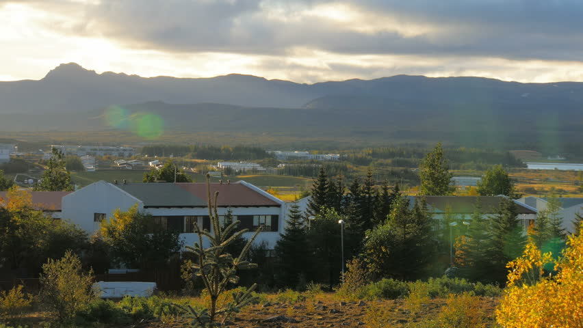 sunrise over small houses and huge mountains, fall in Breidholt Reykjavik, Iceland