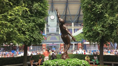 FLUSHING, NEW YORK - SEPT 1, 2016: Arthur Ashe Statue stands in front of USTA at Flushing Meadows at famed tennis tournament in Queens.