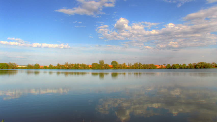 Reflexions of clouds over water, HD time lapse clip, high dynamic range imaging