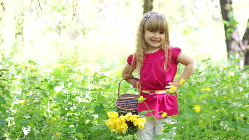 Happy girl with basket in forest
