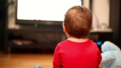 Little boy watching television in home
