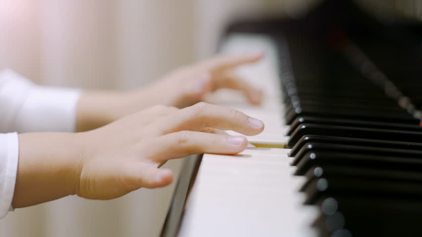 Child playing piano.
Side view of a child playing piano. Close up on piano keys, child hands and fingers. | Shutterstock HD Video #22874221