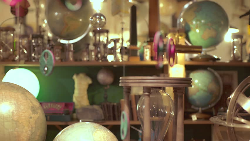 young woman in antique shop plays with a globe