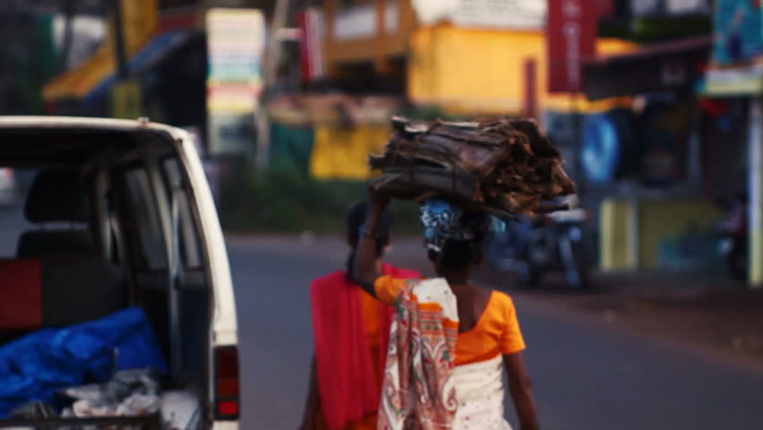 Woman is carrying firewood on her head