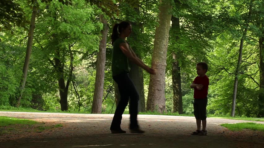 mum playing with her son in a park