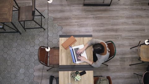 Top view. Businesswoman working on laptop in cafe 4k