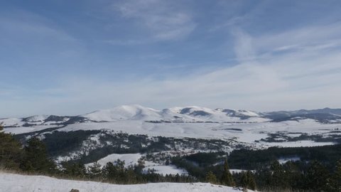 Tilting on mountain region of western Serbia by winter 4K 2160p 30fps UltraHD footage - Zlatibor tourist resort with snowed hills 3840X2160 UHD video