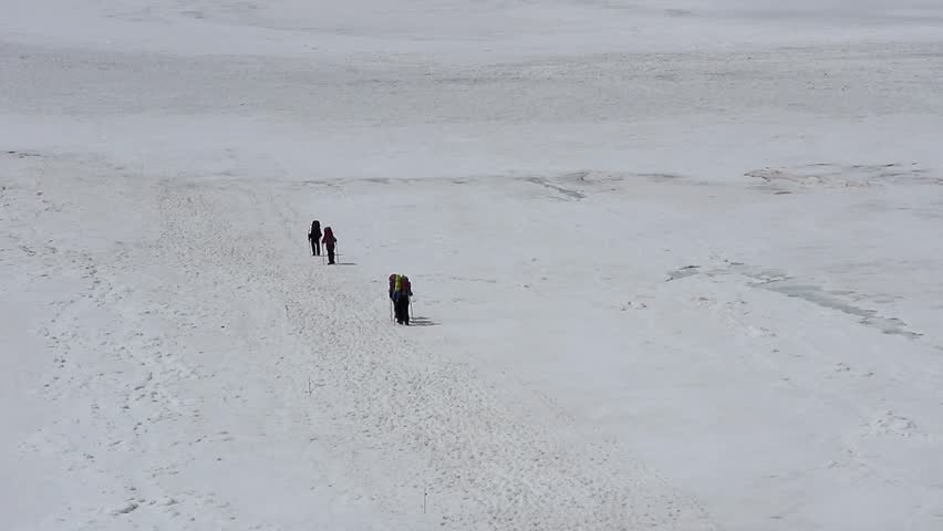 Group of climbers goes up to the Mount Elbrus from north side.
Climbers on the glacier at height 3000 meters.
The top of Mount Elbrus with clouds covering.