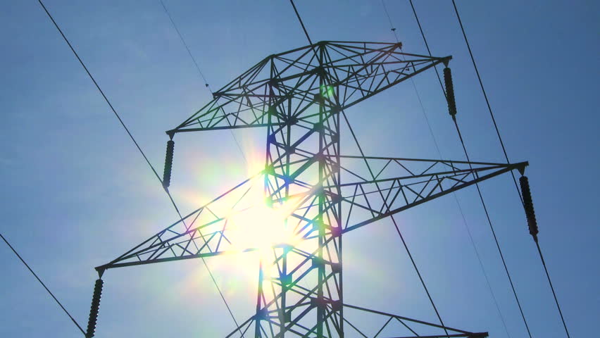 Time lapse of the sun behind an electricity pylon