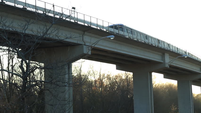 Elevated Atlanta MARTA train with tilt up to white sky.