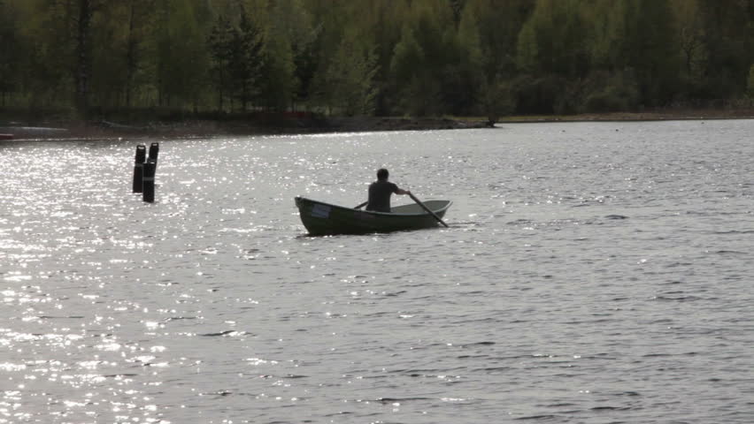 Rowing Boat Floats on the Lake
