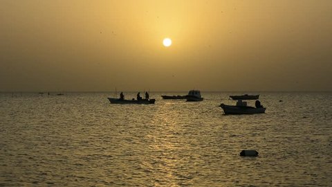 Silhouette of fishing boats and fisher men at sea in morning hours - Bahrain