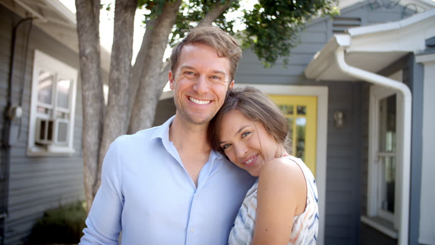 Portrait Of Happy Couple Standing Outside New Home With Keys Royalty-Free Stock Footage #22915282