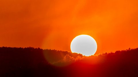 Sunset, sunrise red sky. Beautiful hot orange sun. Summer nature evening background. Big large sun set time lapse. Closeup red sunset dawn timelapse. Huge scenic golden sun heat. Warm desert climate.