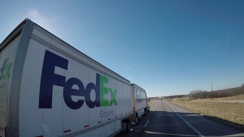 "FedEx" Semi-Truck Passing the viewer on a rural Interstate. | Boonville, Missouri, USA | Jan. 2017
