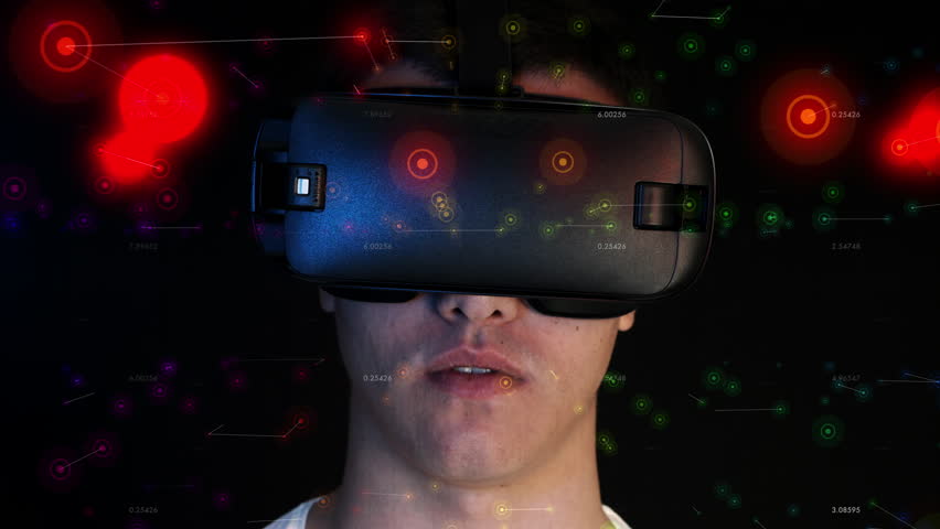 Smiling young man wearing VR Headset experiencing virtual reality. 3D objects flying around head. Royalty-Free Stock Footage #22943242