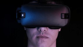 Close-up shot of a young man wearing VR Headset playing virtual reality games. Futuristic hud around him. - Powered by Shutterstock - Get 15% off with code: PIKWIZARD15