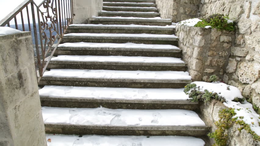 Stairs of a city covered with snow.