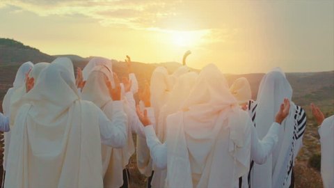 Jewish men praying With tefillin and shofar in sunset
