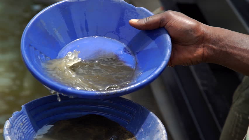 African man are working to sift the sand for gold mining. Detail
