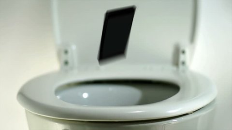 Phone falling into a toilet bowl.
Smart or mobile or cell phone making a splash as it lands in a toilet.