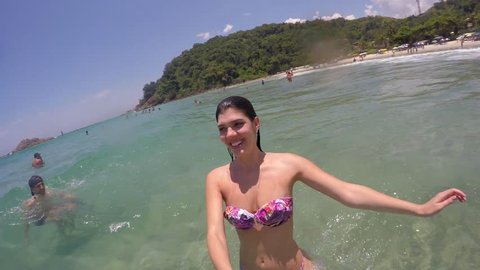 Woman taking a selfie and having fun in a Beach in Brazil