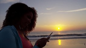 Ethnic African American female at sunrise with headphones and dancing to music taking a selfie photo RED DRAGON