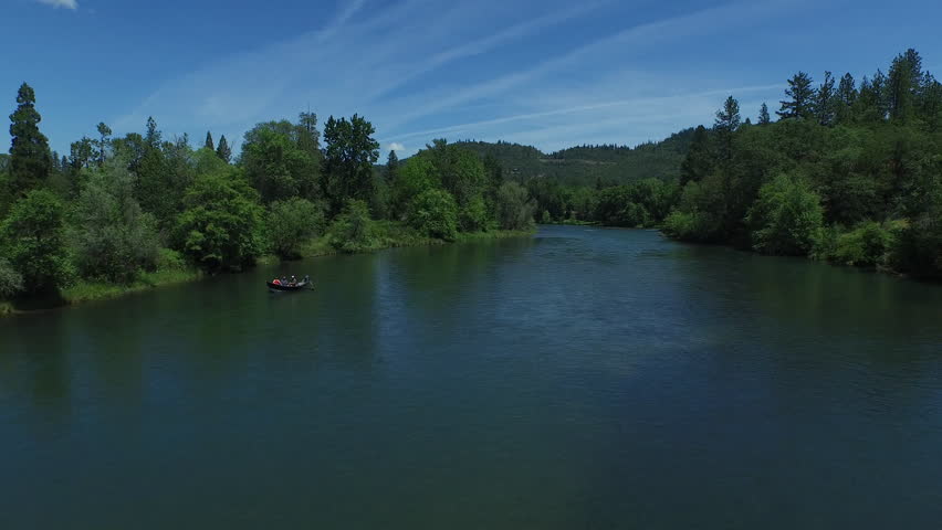 Aerial Shot of Fishermen in Boat on Blue River