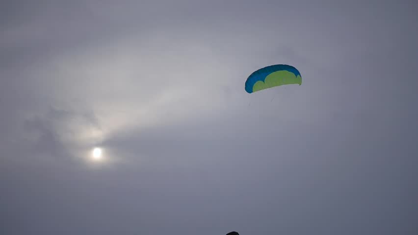 young people learn to control the kite, launching it into the sky, slow motion