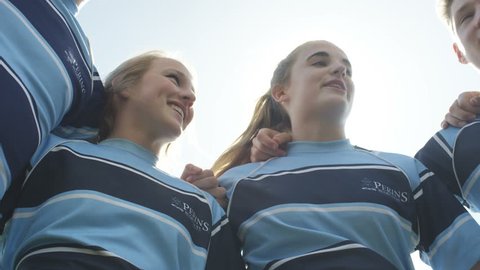 4K Teen group in a huddle on school sports field having team talk before a game Dec 2016-UK