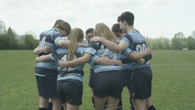 4K Young rugby players (male & female) in a huddle on school sports field Dec 2016-UK - Powered by Shutterstock - Get 15% off with code: PIKWIZARD15