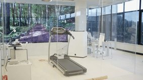 4K Man with personal trainer using treadmill in modern gym Dec 2016-UK