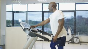4K Man using treadmill in gym with view of natural environment on video screen Dec 2016-UK