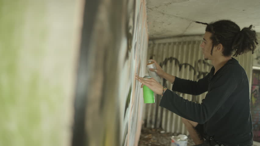 4K Masked graffiti artist using image on phone to copy portrait onto city wall Dec 2016-UK