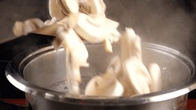 Falling of sliced mushrooms in metal pan with boiling soup, slow motion 250 fps - Powered by Shutterstock - Get 15% off with code: PIKWIZARD15