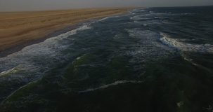 Aerial view drone video of Namibian Atlantic coastline, Zeila L-758  Walvis Bay shipwreck and sand beach, surf break line, Skeleton Coast Park landscape with ocean background at Namibia's west coast