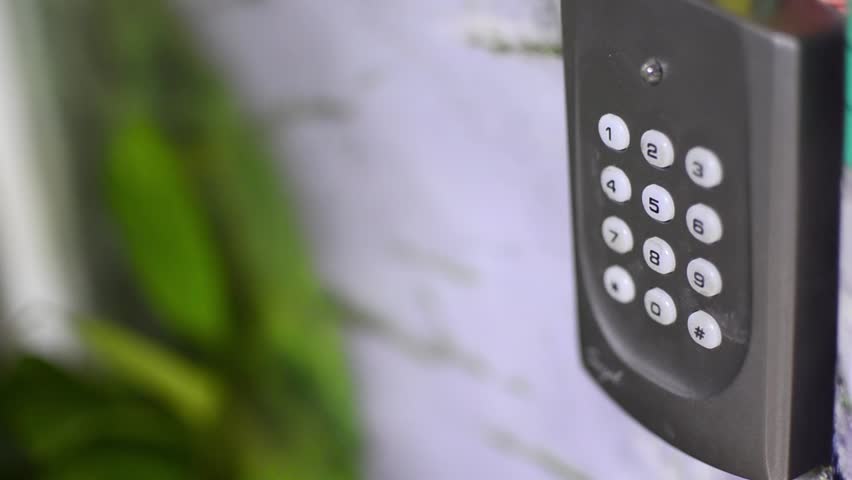 Door hacking. Opening the door with number combination with hand and entering wrong code