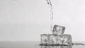Trickle of water in a super slow motion flowing on ice cubes against a grey background - Powered by Shutterstock - Get 15% off with code: PIKWIZARD15