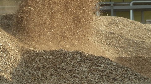 Loader pouring wood chips from its bucket