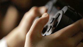 Man playing video game with a joystick. close-up of children's hands