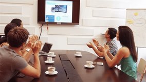 Business executives applauding during a video conference in the conference room 4k