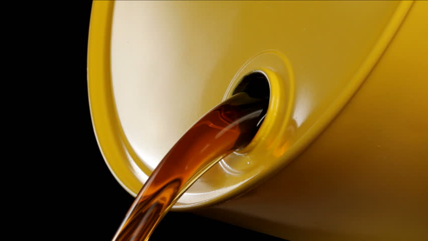 Oil pours out of yellow drum