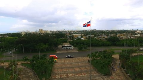 The camera slowly flies past a waving flag of the Dominican Republic