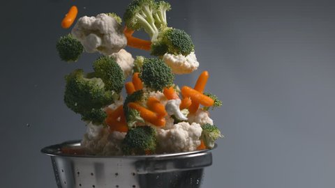Vegetables flying out of colander in super slow motion, shot on Phantom Flex 4K