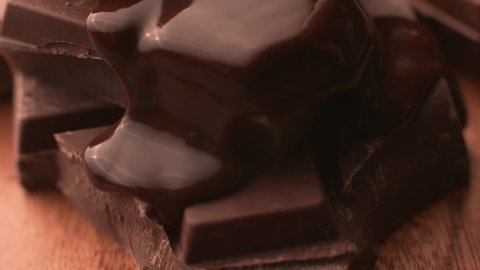Melted chocolate pouring over chunks of chocolate in super slow motion, shot on Phantom Flex 4K